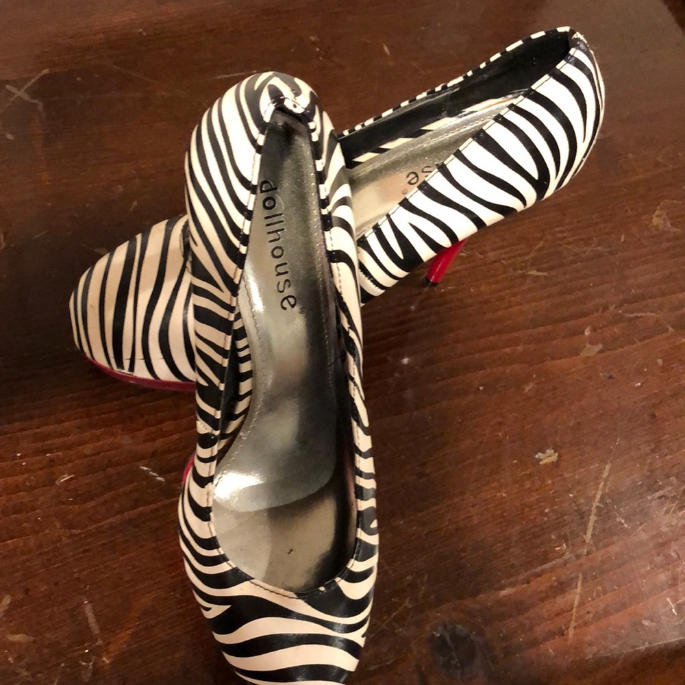 Black and white heels with red heel